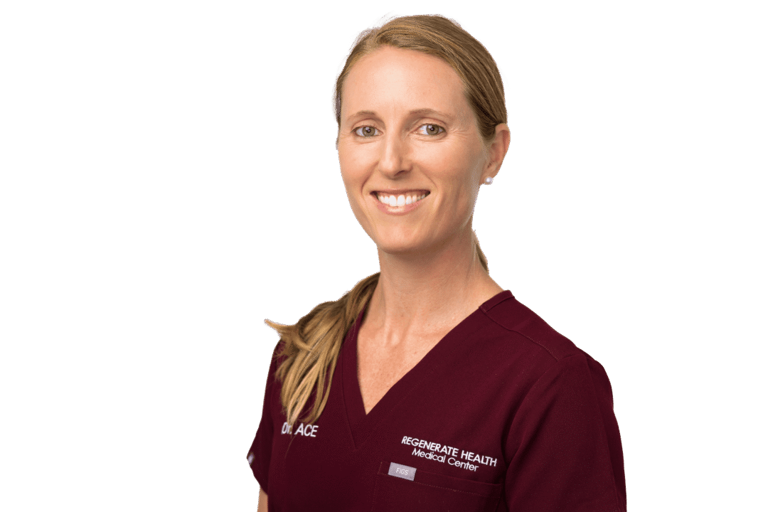 Female practitioner in burgundy scrubs smiling in professional horizontal portrait