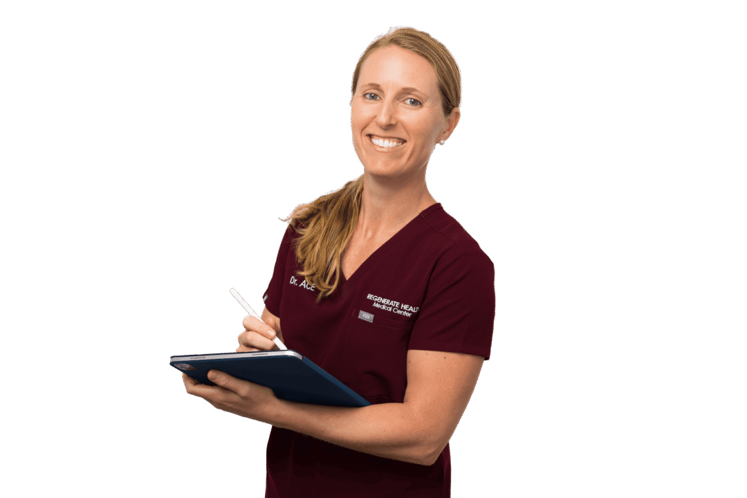 Female practitioner in burgundy scrubs smiling in professional horizontal portrait with a tablet her hands