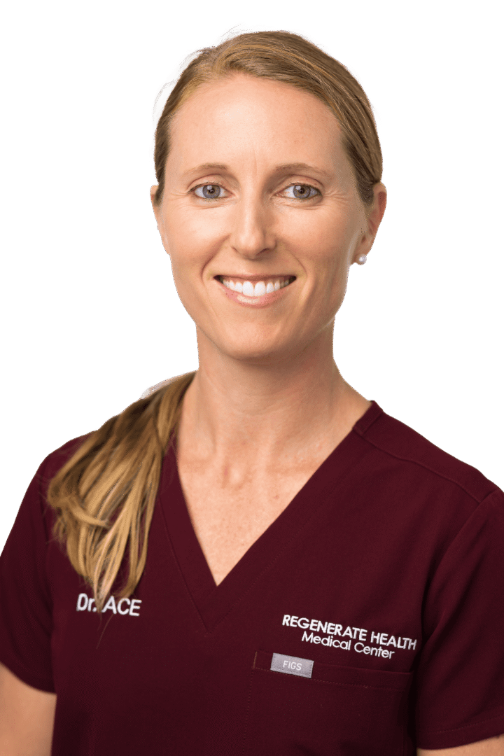 Medical practitioner in burgundy scrubs smiling in a vertical staff headshot