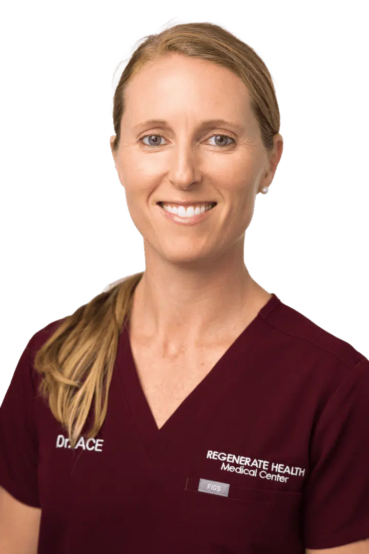 Medical practitioner in burgundy scrubs smiling in a vertical staff headshot
