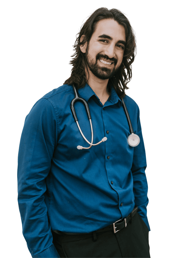 Female medical practitioner in teal scrubs smiling in vertical staff portrait.