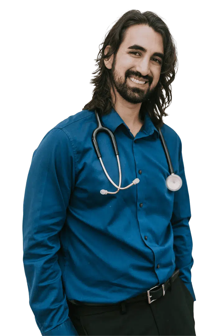 Female medical practitioner in teal scrubs smiling in vertical staff portrait.