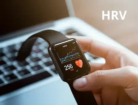 how-to-increase-hrv-naturally Person using wearable health tracker to monitor HRV and recovery