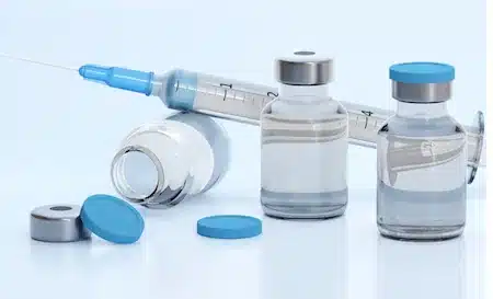 Vials and syringe representing GLP-1 injectable medication