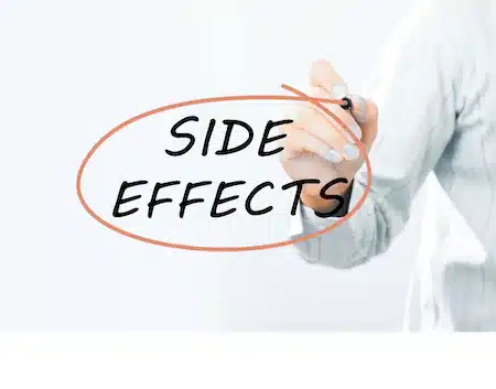 Hand circling the words "side effects" on a whiteboard